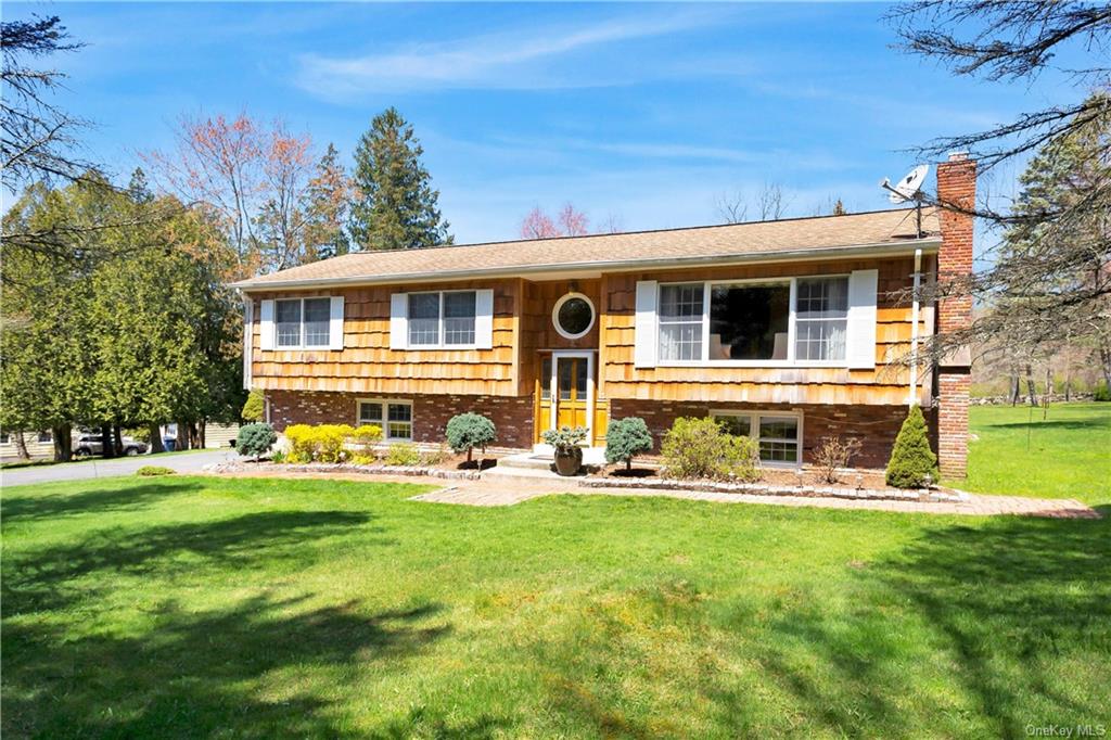 a front view of house with outdoor seating and yard
