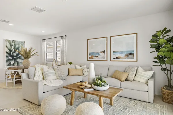 a living room with furniture and a potted plant