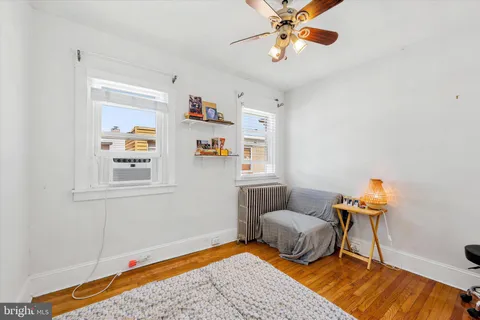 a bedroom with furniture and a rug