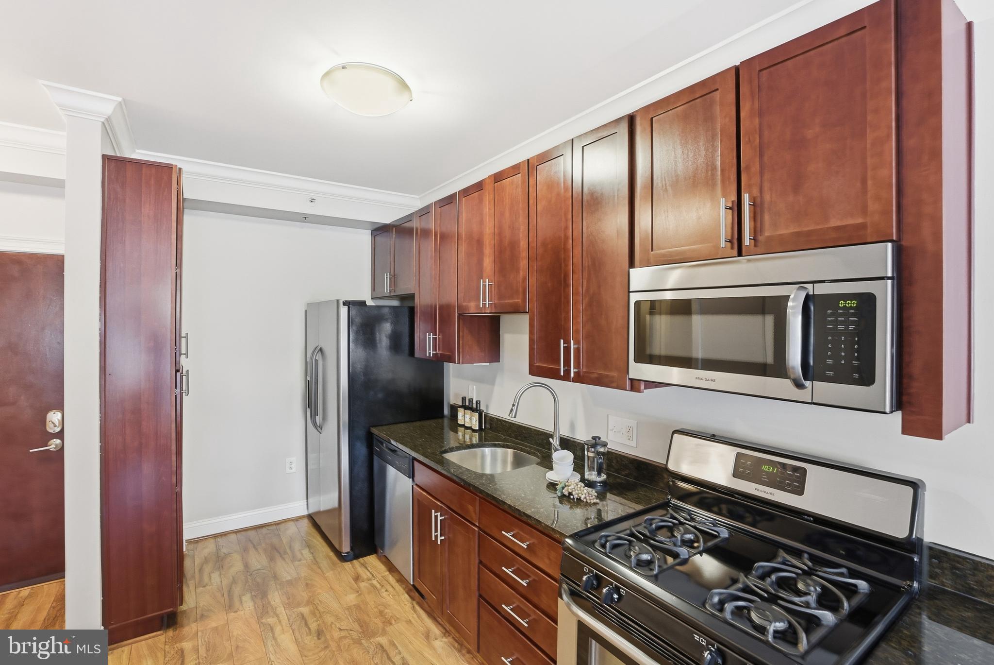 6301 Edsall Road, Unit 106 Alexandria, VA 22312 - Photo 2 of 28 a kitchen with stainless steel appliances granite countertop a stove refrigerator and microwave
