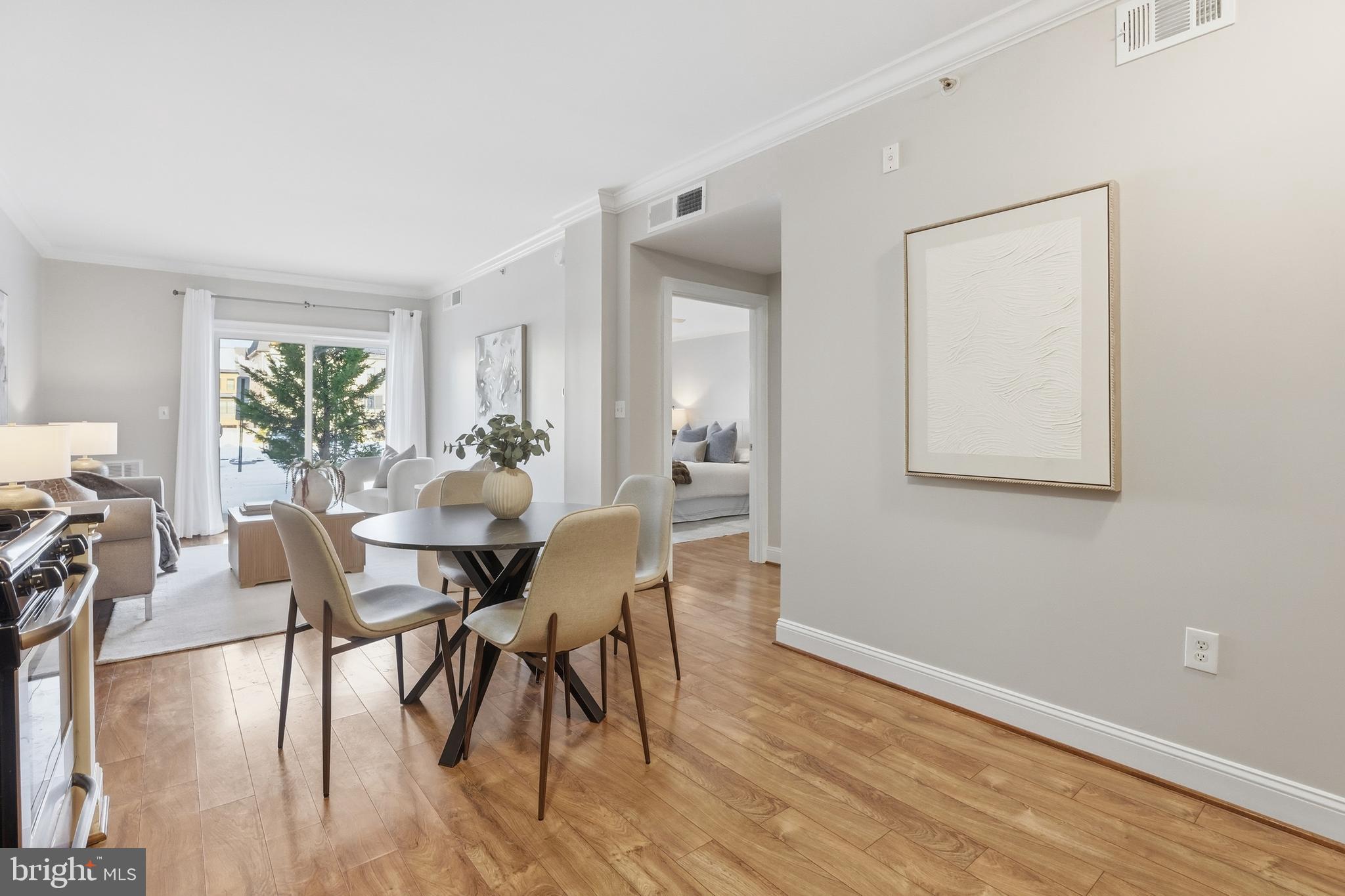 6301 Edsall Road, Unit 106 Alexandria, VA 22312 - Photo 3 of 28 a view of a dining room with furniture and wooden floor