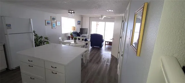 a view of a hallway with furniture and a window