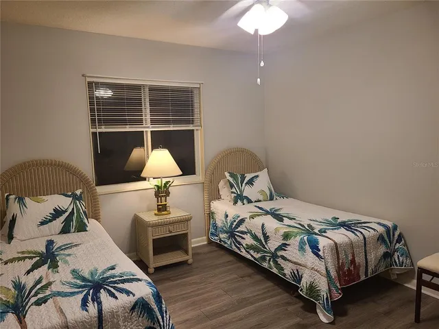 a bedroom with a bed and a lamp