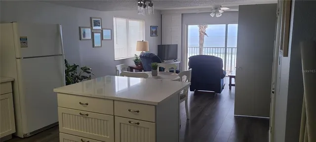 a view of kitchen and dining area with chandelier