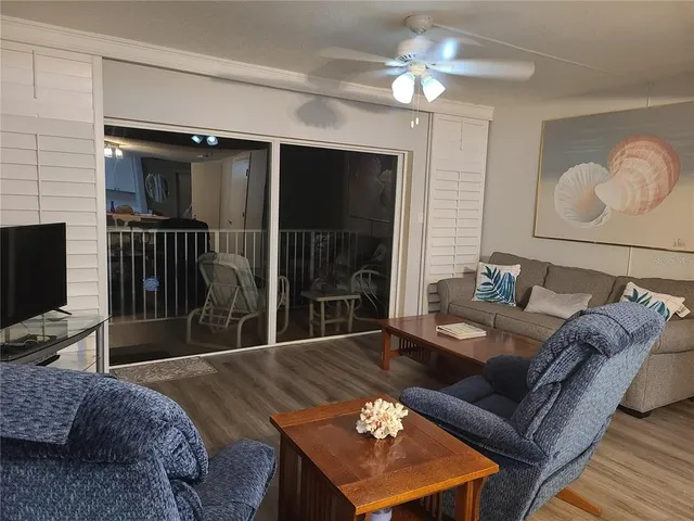 a living room with furniture a lamp and a flat screen tv