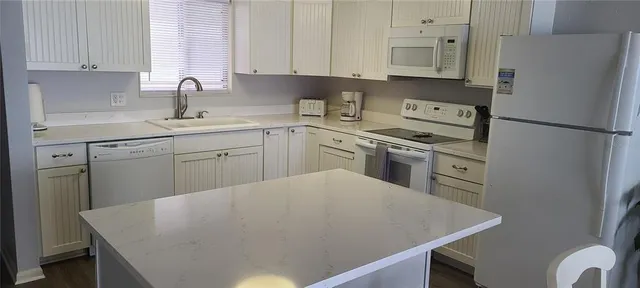 a kitchen with a sink a stove and refrigerator