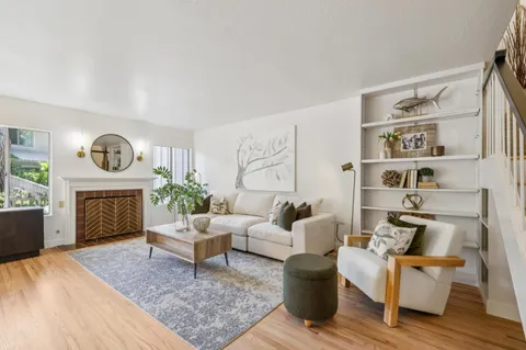 a living room with furniture and wooden floor