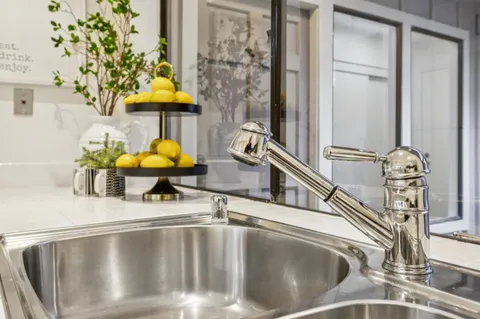 a kitchen with white cabinets sink and white appliances