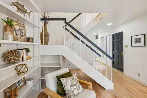 a spacious bedroom with a bed and a potted plant