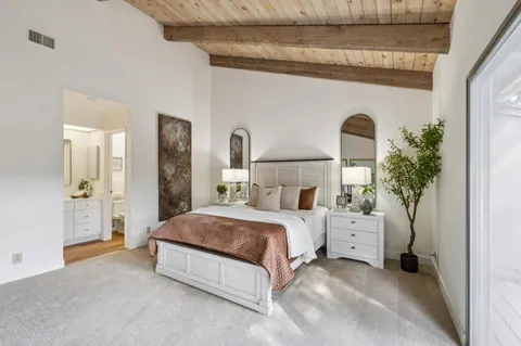 a view of a balcony with wooden floor and iron gate