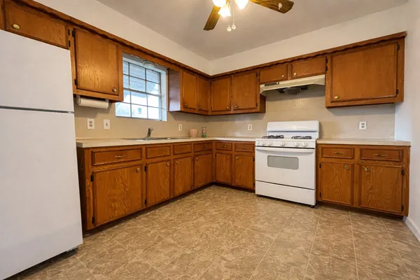a kitchen with a sink stove and cabinets