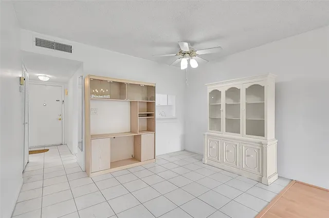 a view of livingroom with furniture chandelier fan and refrigerator