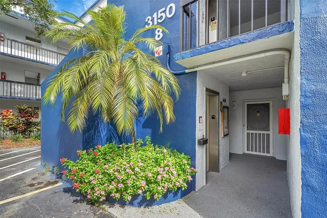 a view of a house with a flower garden