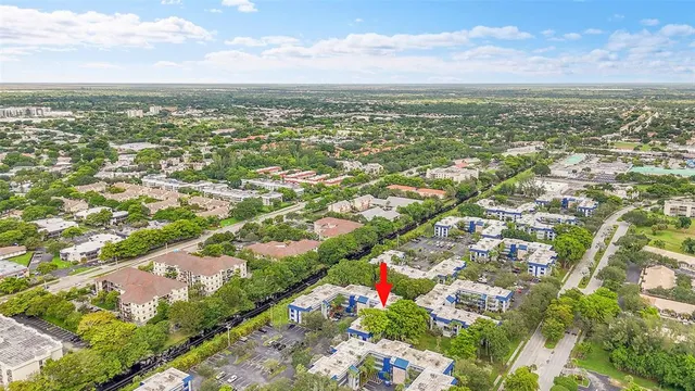 an aerial view of residential building with yard