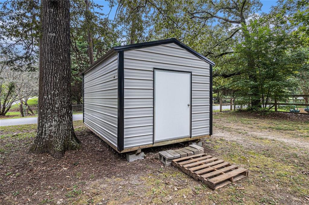133 North Bellview Road Aragon, GA 30104 - Photo 22 of 22 a small barn with a small yard and a large tree