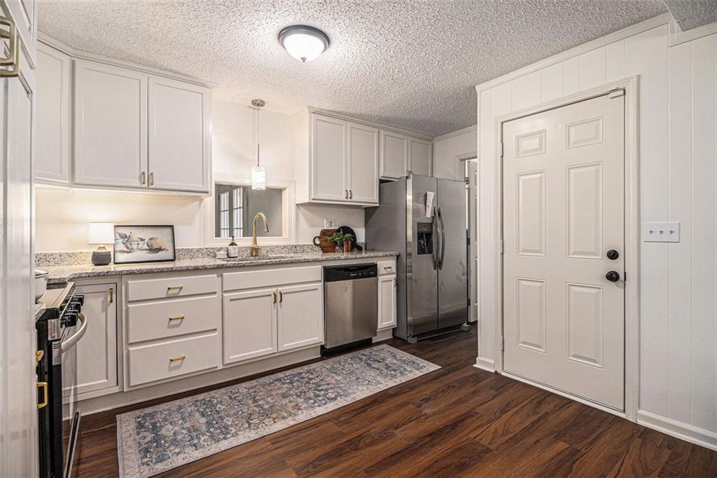 133 North Bellview Road Aragon, GA 30104 - Photo 7 of 22 a kitchen with a refrigerator stove and white cabinets