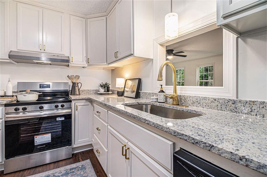 133 North Bellview Road Aragon, GA 30104 - Photo 8 of 22 a kitchen with granite countertop a sink stainless steel appliances wooden floor and counter space