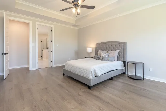 a bedroom with a bed and a chandelier