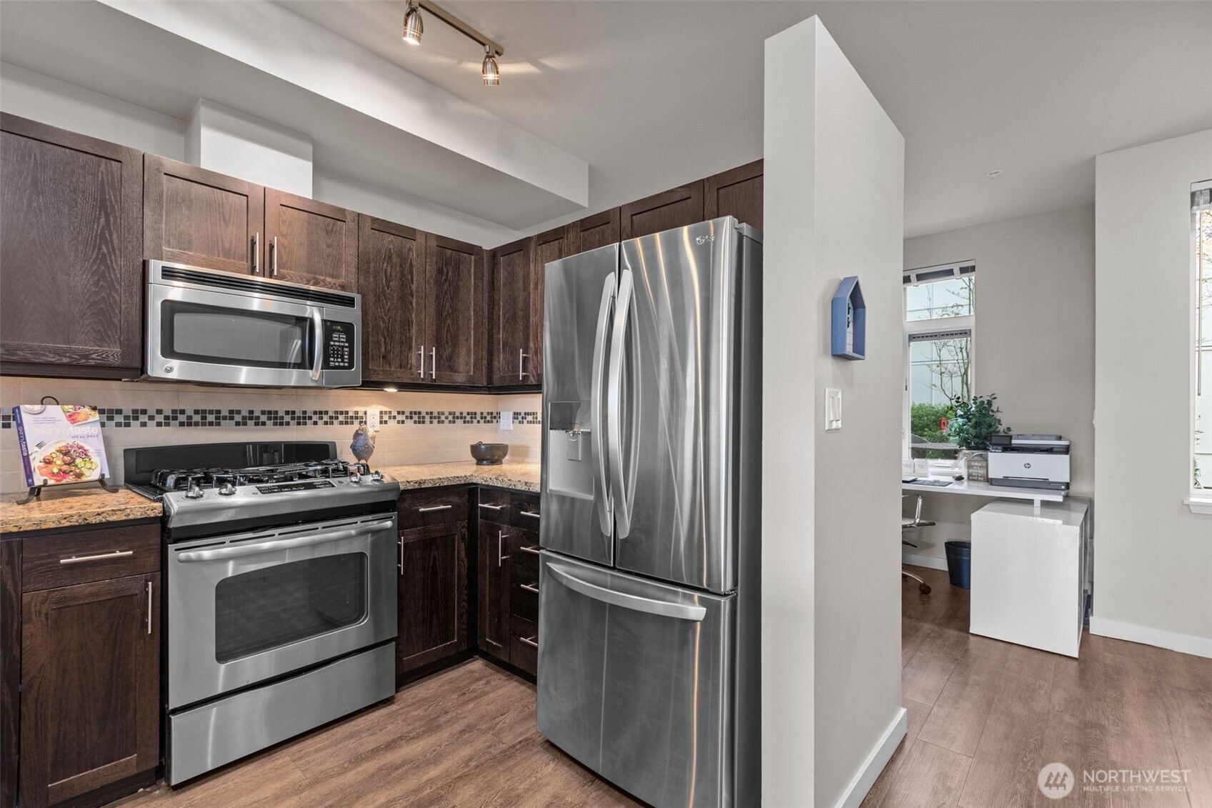 15100 6th Avenue Southwest, Unit 305 Burien, WA 98166 - Photo 13 of 40 a kitchen with cabinets stainless steel appliances and wooden floor