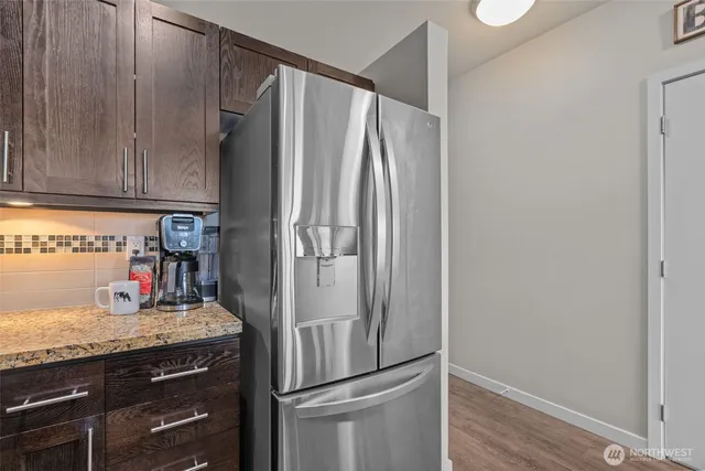 a kitchen with stainless steel appliances granite countertop a refrigerator and a sink