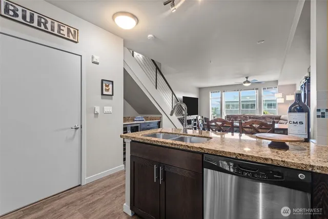 a kitchen with sink and refrigerator