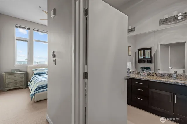 a en suite bathroom with a double vanity sink a mirror a bathtub and window