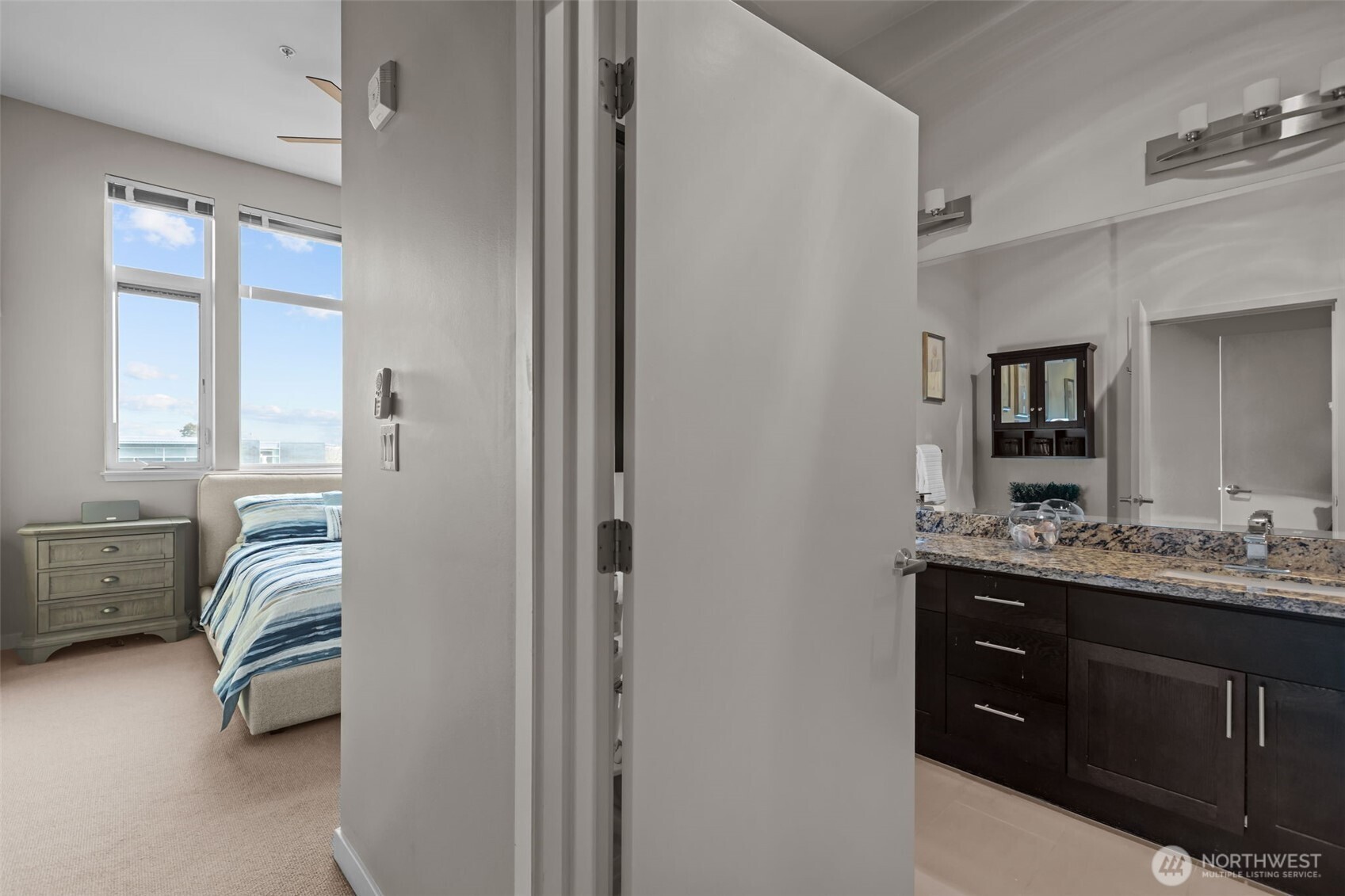 15100 6th Avenue Southwest, Unit 305 Burien, WA 98166 - Photo 20 of 40 a en suite bathroom with a double vanity sink a mirror a bathtub and window