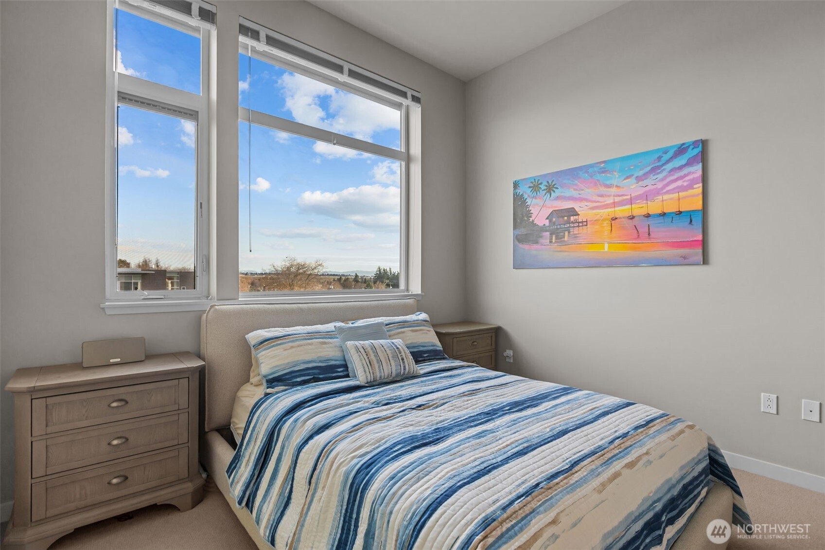 15100 6th Avenue Southwest, Unit 305 Burien, WA 98166 - Photo 21 of 40 a bedroom with a bed and a painting on the wall