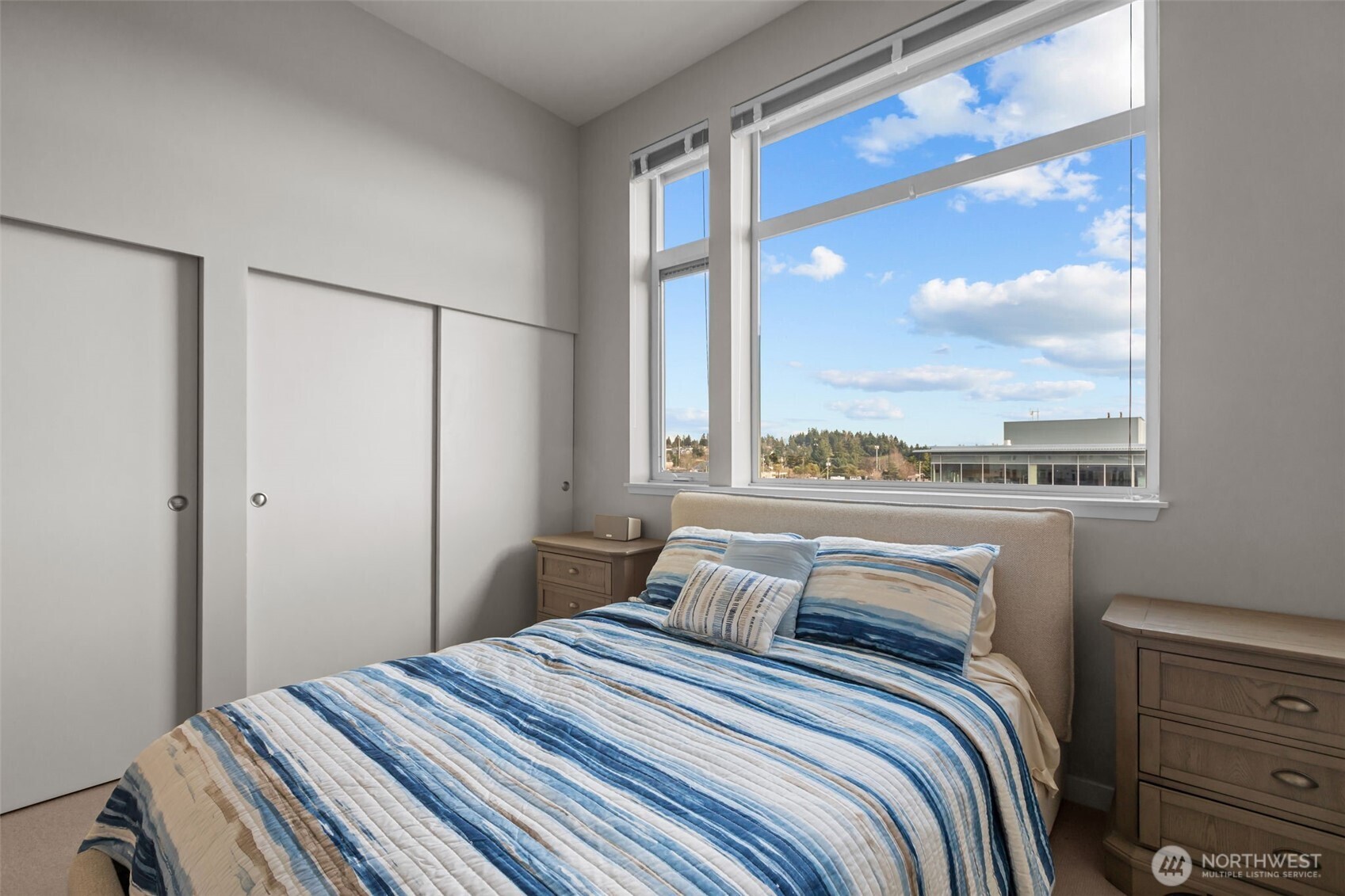 15100 6th Avenue Southwest, Unit 305 Burien, WA 98166 - Photo 22 of 40 a bedroom with a large window and a bed