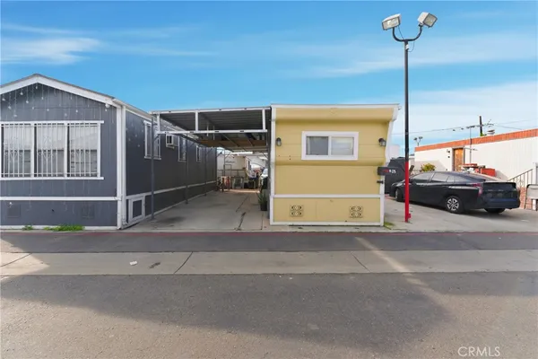 a view of a house with wooden fence