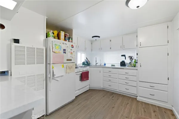 a kitchen with cabinets a sink and appliances