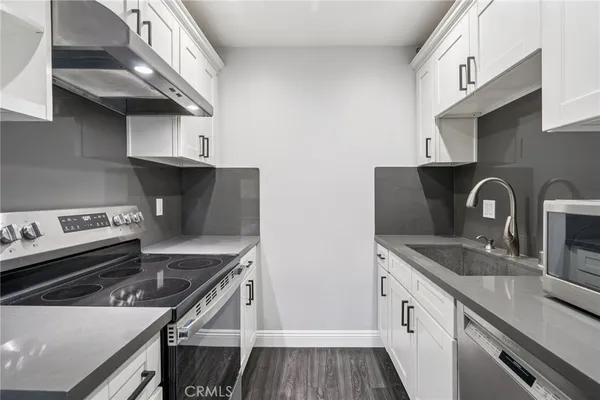 a kitchen with granite countertop a stove and a sink