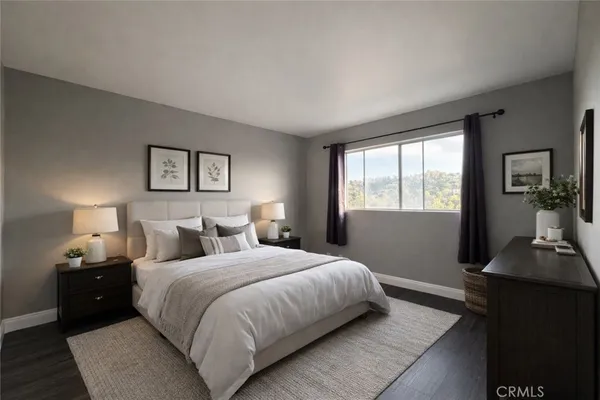 a bedroom with a bed and a lamp on table