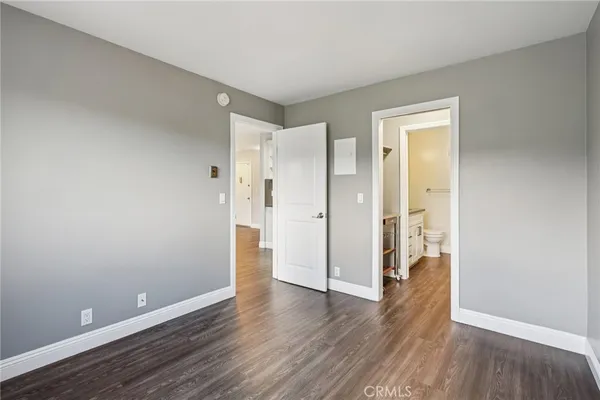 a view of wooden floor and windows in a room