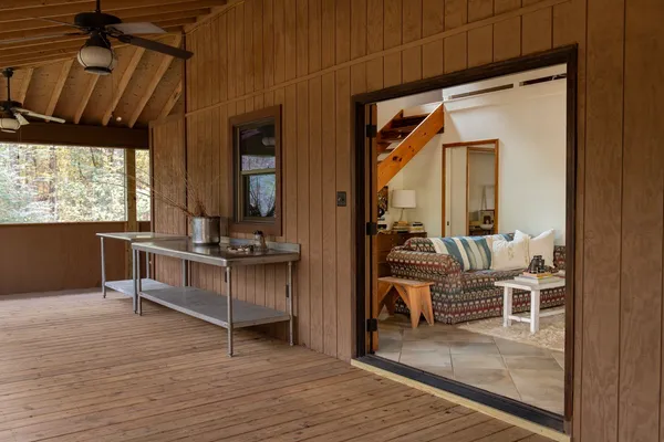 a living room with furniture a dining table and chairs with kitchen view