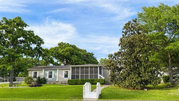 a big house with trees in front of it