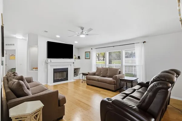 a living room with furniture a fireplace and a flat screen tv