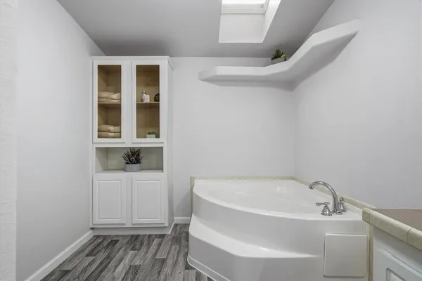 a white bath tub sitting next to a window