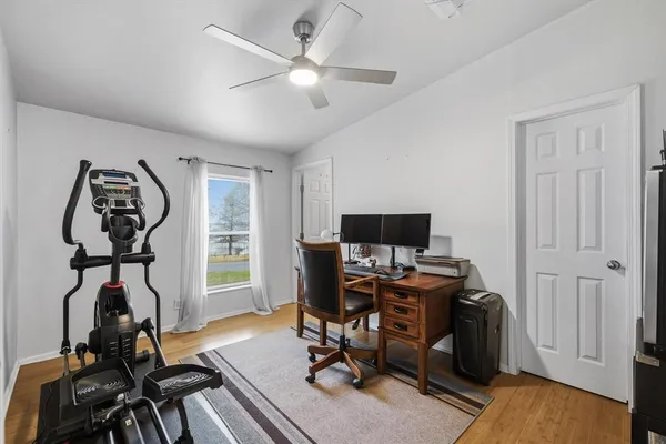 a view of a workspace with furniture and a window