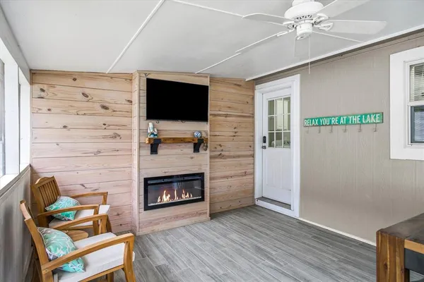 a living room with furniture a flat screen tv and a fireplace