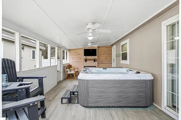 a living room with stainless steel appliances kitchen island granite countertop furniture and a flat screen tv
