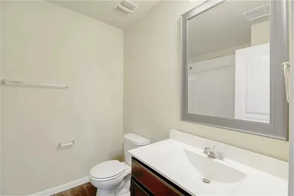 a bathroom with a sink a toilet and a mirror