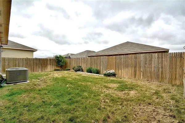 a backyard of a house with table and chairs