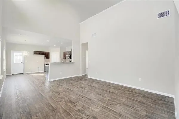 a view of a kitchen with wooden floor and kitchen