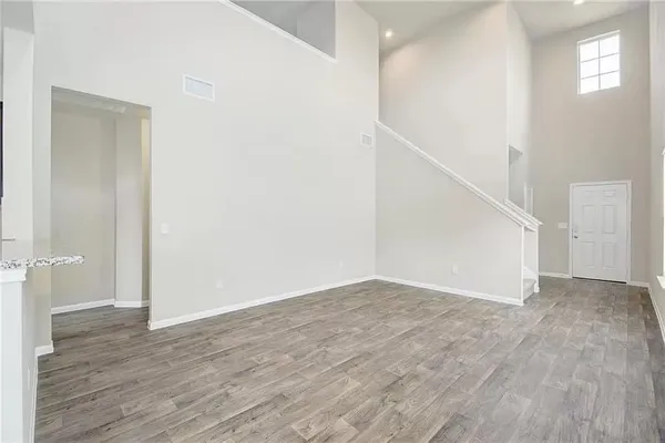 a view of an empty room with wooden floor