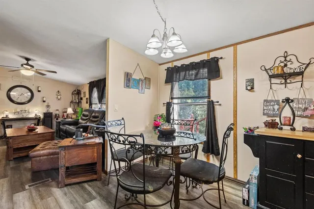 a living room with furniture a chandelier and a flat screen tv