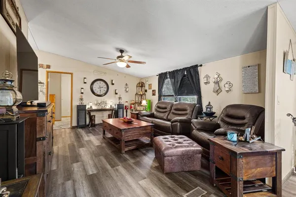 a living room with furniture and wooden floor