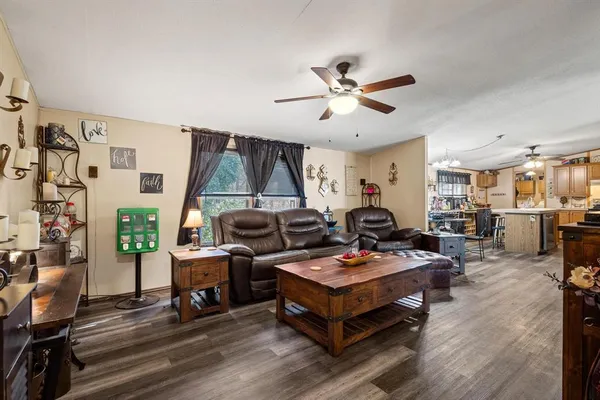 a living room with furniture a rug and a window