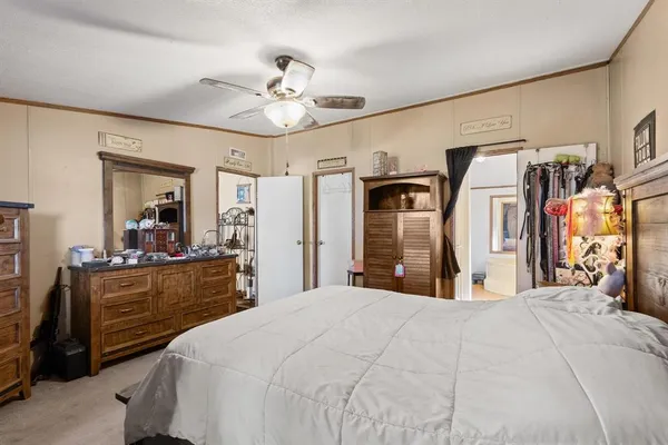a bedroom with a large bed and a chandelier