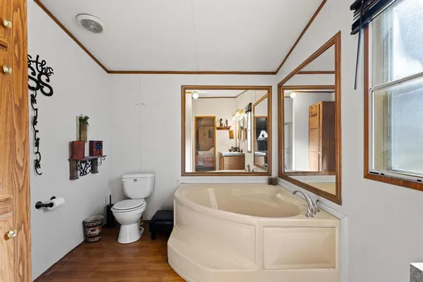a white bath tub sitting next to a toilet